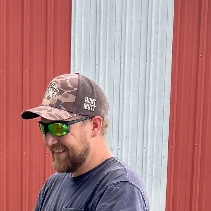 Trucker Hat in Brown Camo With Hunt Mutt Logo Side View lifestyle
