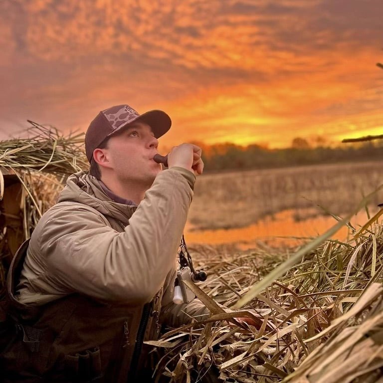 Hunter wearing Hunt Mutt trucker hat outdoors